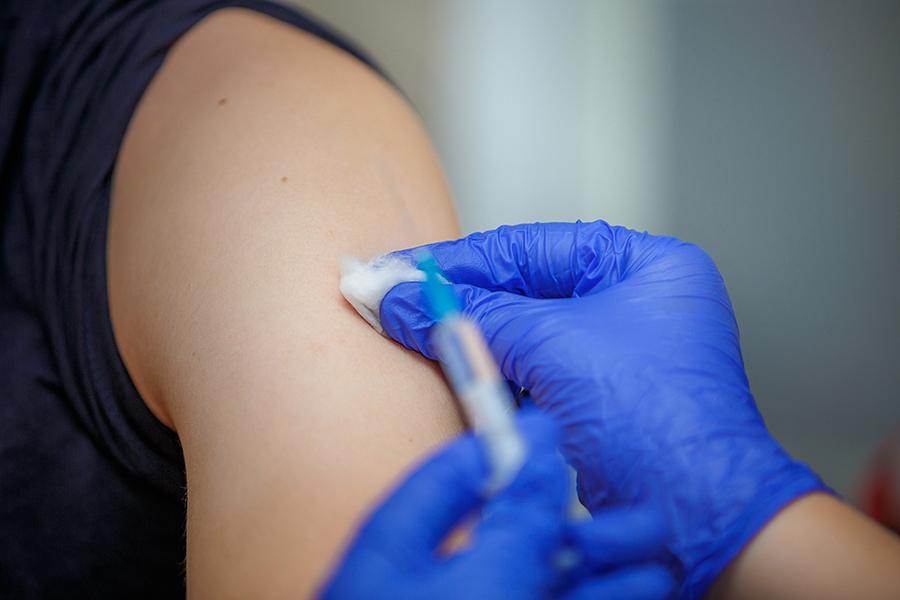 Doctor administering flu shot to patient