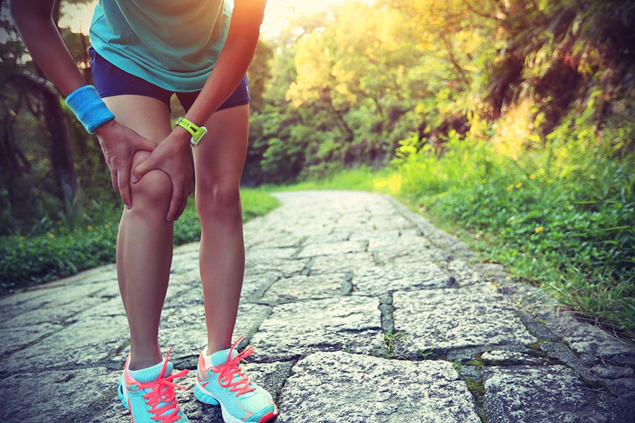 Woman holding knee in pain