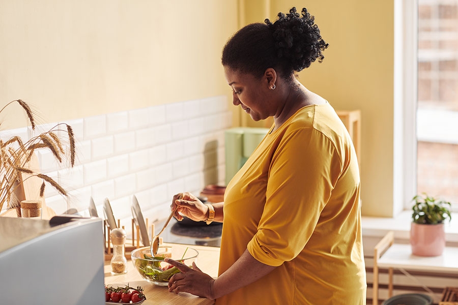 Woman cooking healthy meal before bariatric surgery