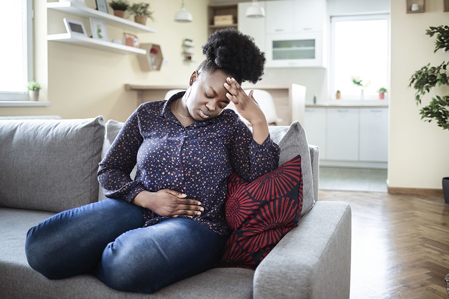 Woman with UTI holding stomach