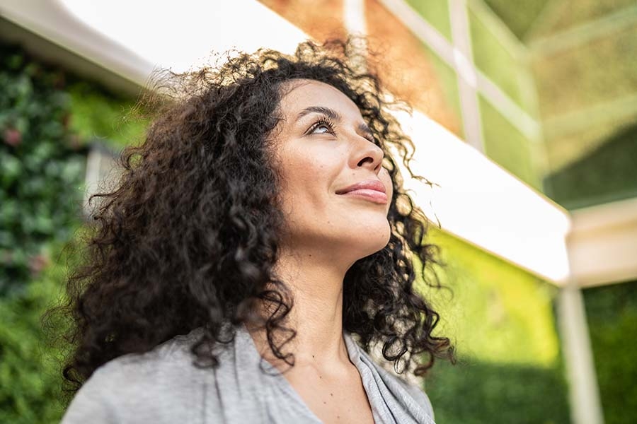 Woman outdoors looking up