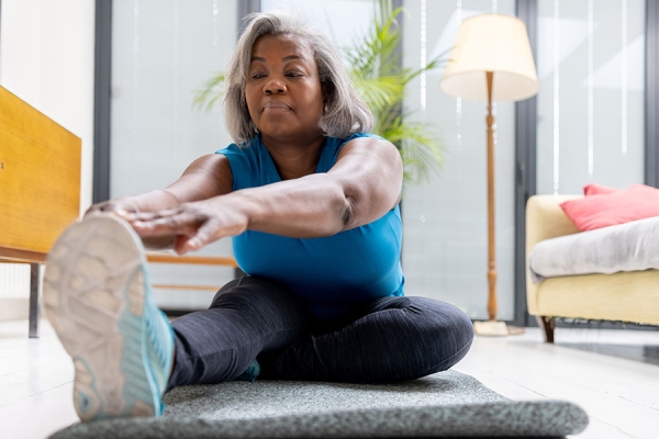 Older woman stretching her legs
