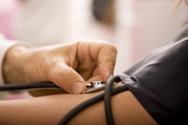 Doctor taking patients blood pressure